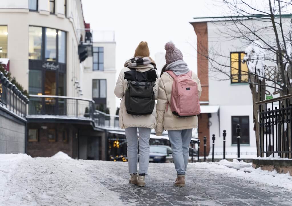 Two friends walking around together in Whistler's village in winter